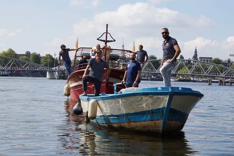 Amsterdam: Canal Cruise on a Wooden Refugee Boat - A wooden refugee boat with refugee stories at the helm