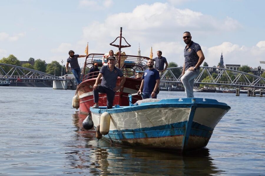 Amsterdam: Canal Cruise on a Wooden Refugee Boat - Amsterdam history you can actually spot from the water