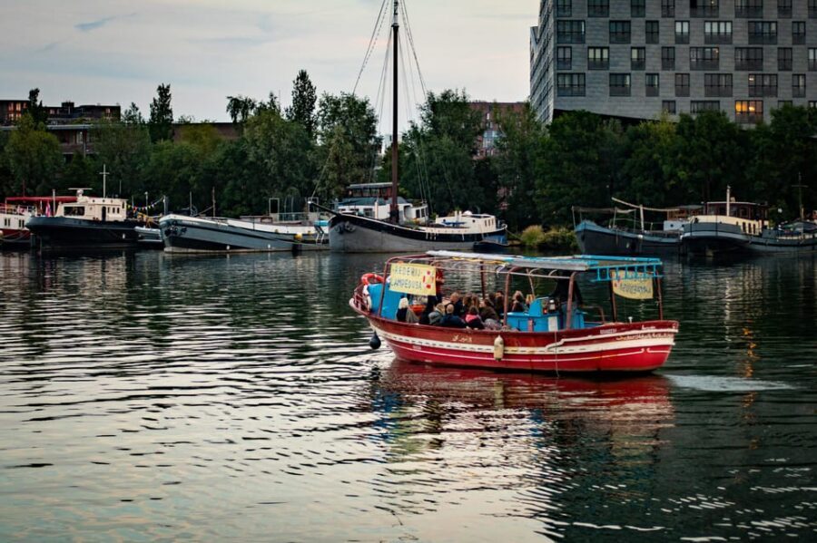 Amsterdam: Canal Cruise on a Wooden Refugee Boat - Social enterprise energy: meaningful conversation with structure
