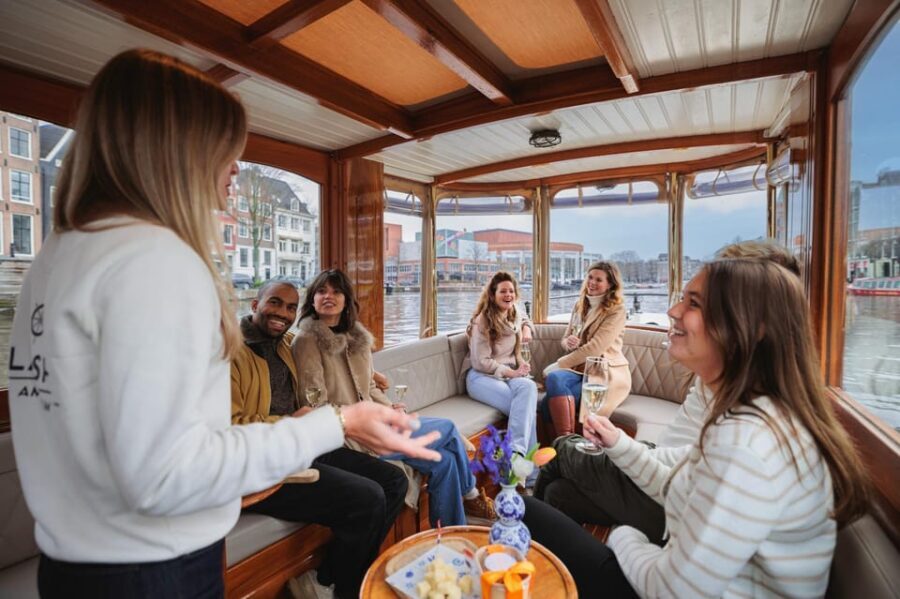Amsterdam: Canal Cruise with Bubbles & Bites - Boarding the Covered Boat: Step, Drinks, and Comfort