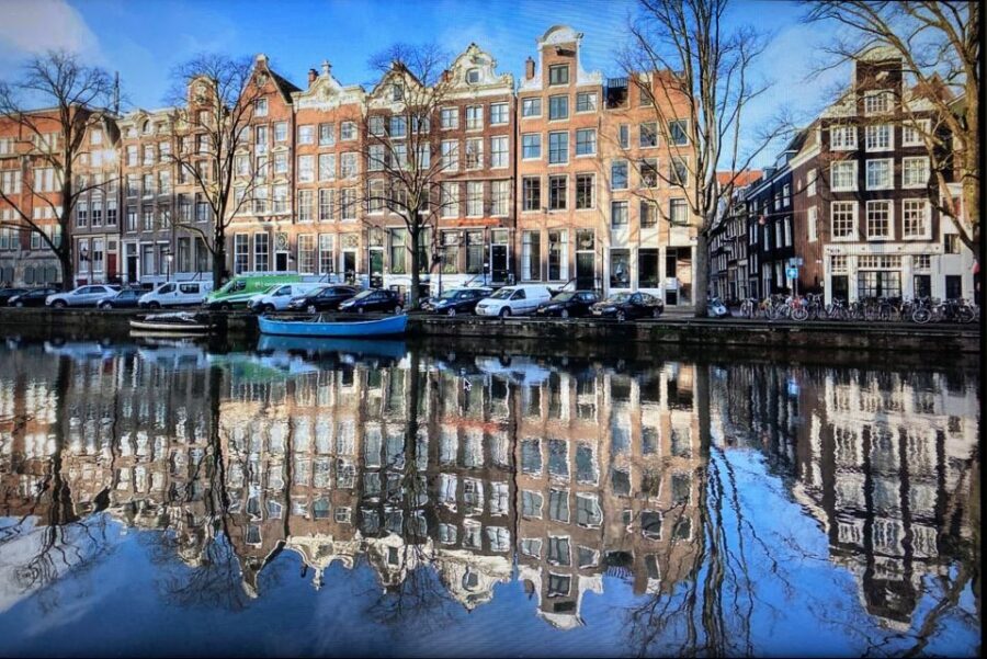Amsterdam: Guided Off-The-Beaten-Track Walking Tour - Westerdoks and houseboats: modern design on top of old water routes