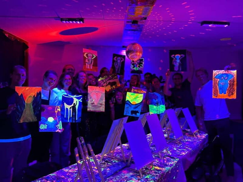Amsterdam: Paint and Sip in the Dark at Rembrandt van Wine - The setup: canvas, neon glow paint, and an apron that helps
