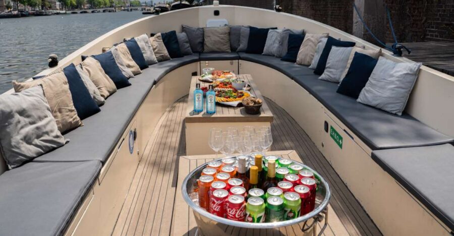 Amsterdam: Private Canal Booze Cruise with Unlimited Drinks - The vibe on board: hosts, skipper, and group energy in real time