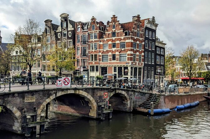 Amsterdam private city walking experience with a local - House on the Three Canals and the Bicycle Bridge Idea