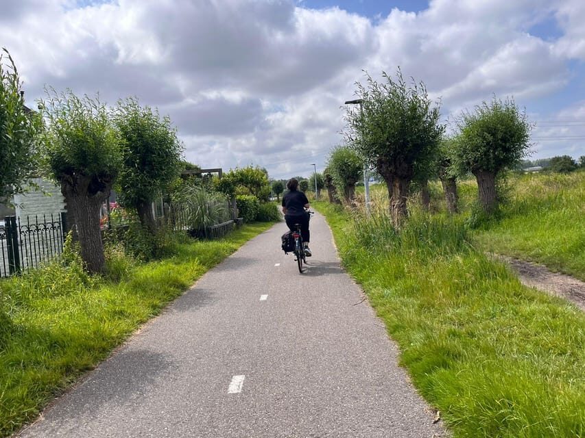 Amsterdam: Rainbow Rural Bike Tour With Local Gay Guide - Ferry Return: A Simple Ride with Picture-Perfect Skyline Views