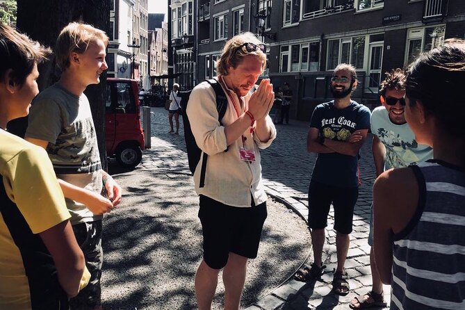 Amsterdam Walking Tour with a local comedian as guide - Dam Square to Damstraat: National Monument energy and the coat-of-arms twist