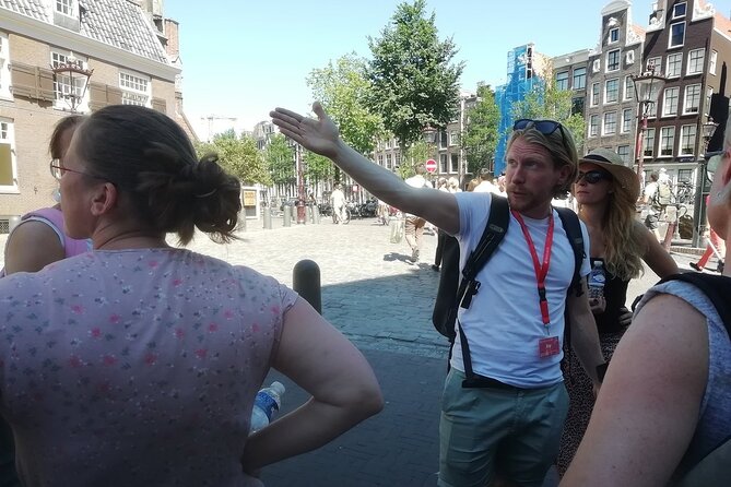 Amsterdam Walking Tour with a local comedian as guide - Grimburgwal canals: classic waterways and a Dutch birthday habit